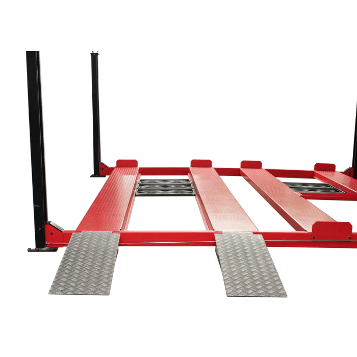 Angled partial view of the Triumph NSS9000 Vehicle Lift showing red runways and diamond-plate approach ramps.