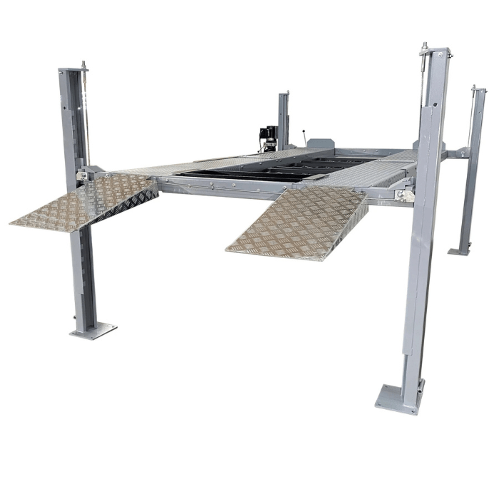 Angled view of the Triumph NSS8X-1 Four-Post Vehicle Lift featuring diamond-plate ramps and sturdy steel columns.