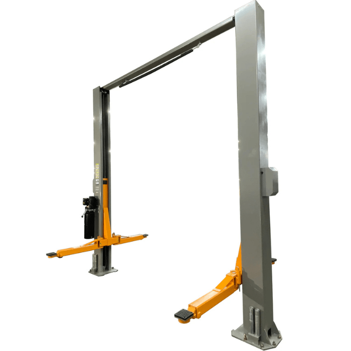 Angled view of the Triumph NTO-11A Vehicle Lift with tall grey posts, bright orange lifting arms, and a top-mounted support bar for ample overhead clearance.