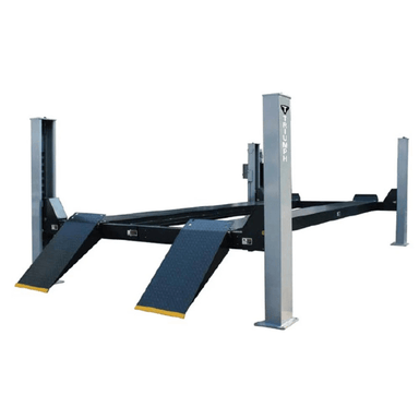 Angled front view of the Triumph NTR-16 Vehicle Lift, featuring heavy-duty steel columns, textured ramps, and a broad platform for high-capacity vehicle support.