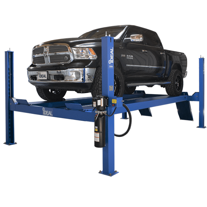 Black RAM 1500 pickup truck raised on a blue iDEAL FP14KC-X 4-post lift.