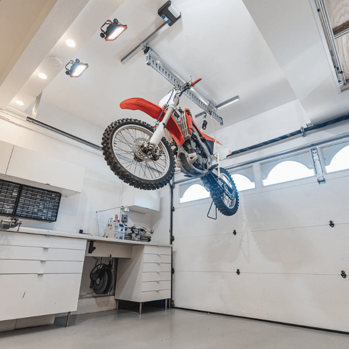 Bottom right side view of the Auxx-One motorized storage lift with a bike attached