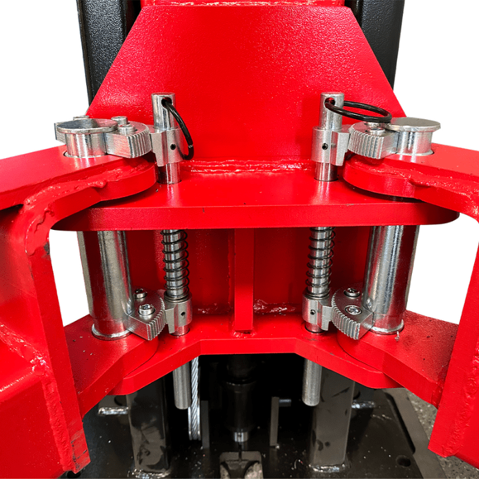 Close-up of arm pivot assembly with heavy-duty pins and dual springs on the Katool 15,000 lb two post vehicle lift.