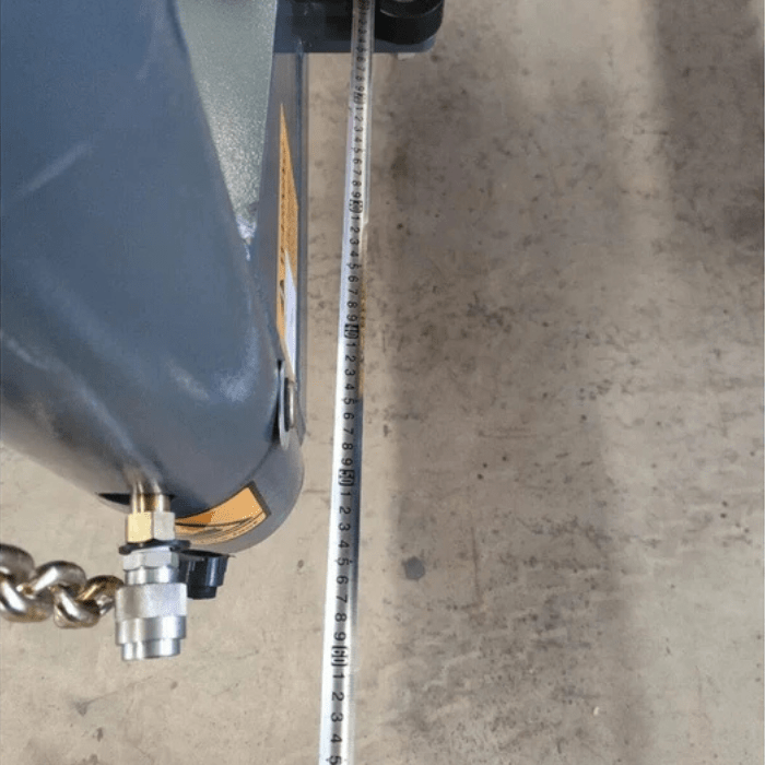 Close-up of measurement tape and hydraulic component on the Katool KT-299U Auto Body Frame Machine for alignment accuracy