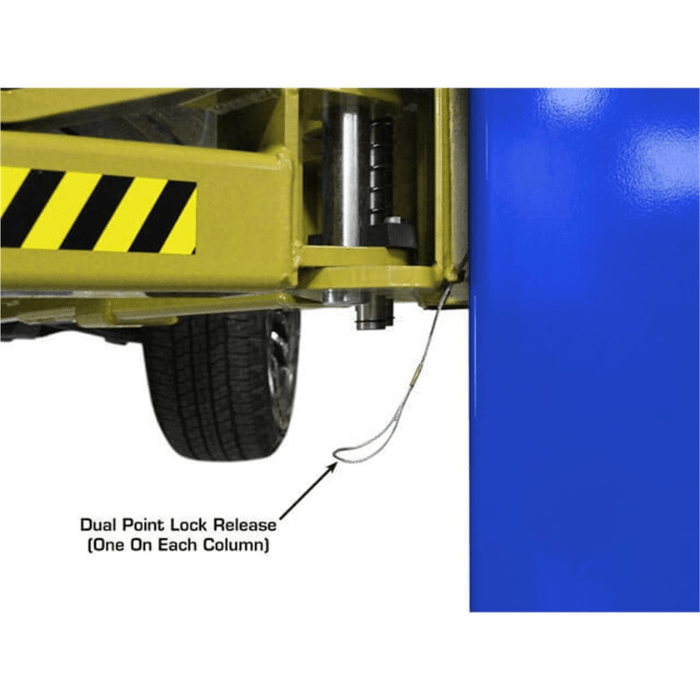 Close-up of the Atlas PVL9BP Baseplate 2-Post Lift showing the dual point lock release cable mechanism attached to the column and lift carriage for synchronized safety locking.
