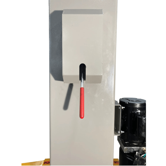 Close-up of the Triumph NT-15 Two Post Lift column showing a red-handled safety release lever and the adjacent hydraulic power unit enclosure.