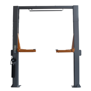 Direct front view of the Triumph NTO-20S Two-Post Vehicle Lift with twin gray columns, orange arms in raised position, and a top-mounted bar designed for overhead cable routing.