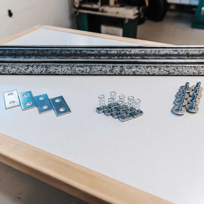 Everything included with the Additional Hardware Kit on a table