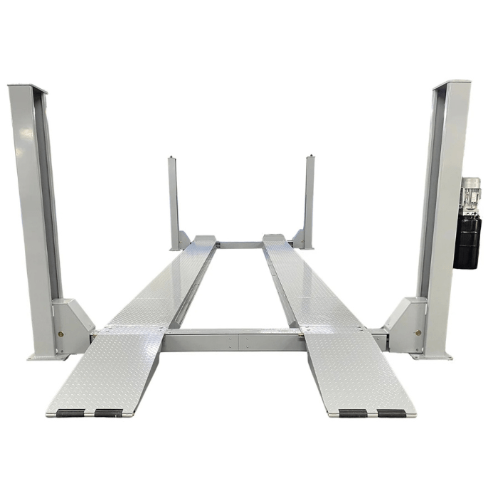 Front approach of the Triumph NTR-32 32,000 lb Heavy-Duty Four Post Vehicle Lift with diamond-plate runways and tall steel columns.