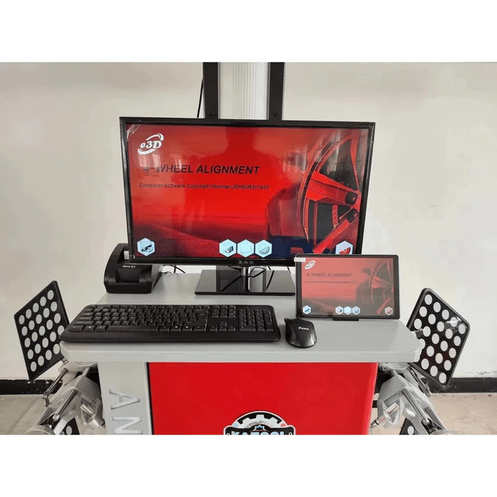 Front view of the Katool AV6 Pro Wheel Alignment Machine’s computer setup with a large monitor, keyboard, mouse, and reflective alignment targets on the sides.