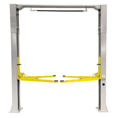 Front view of the Triumph NTO-9AE Lift showcasing its overhead cable system, dual post structure, and extended yellow lift arms for optimal vehicle support.
