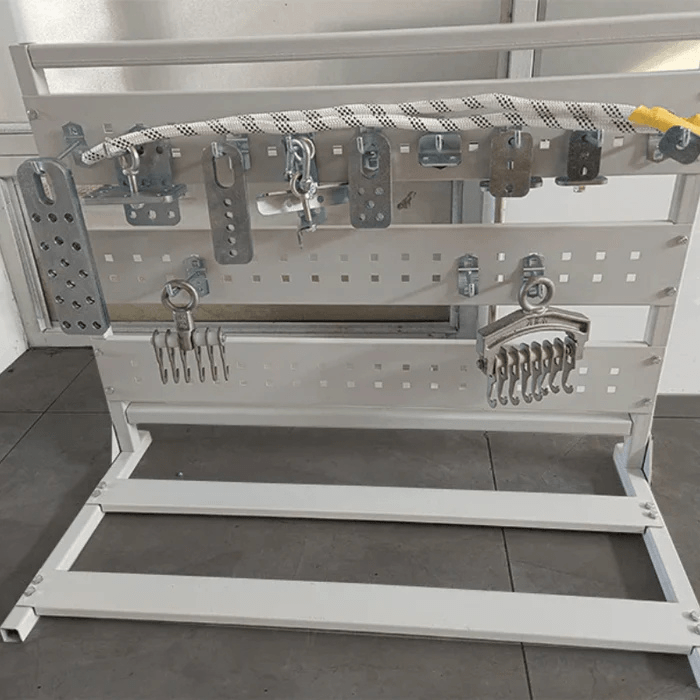 Katool KT-YA260 Auto Body Frame Straightener Accessories – full attachment set displayed on metal rack including clamps, hooks, pulling plates, and chains.