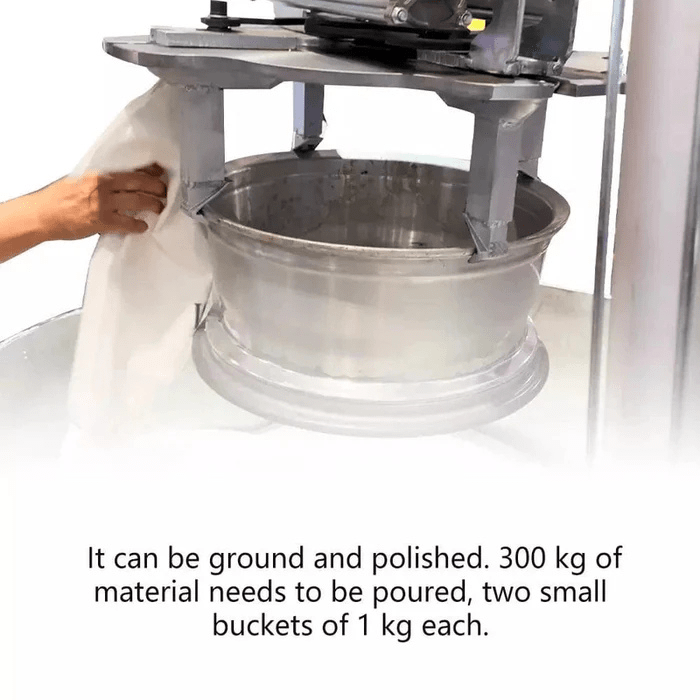 Operator wiping a rim positioned inside the Katool KT-RPM80 Professional Rim Polishing Machine before polishing material is added.