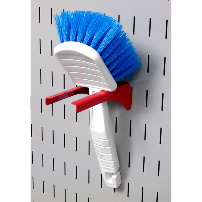 Showing a brush being mounted to a pegboard using accessories from the Perfect Starter Accessory Pack The Most Popular Wall Control Pegboard Hook Set