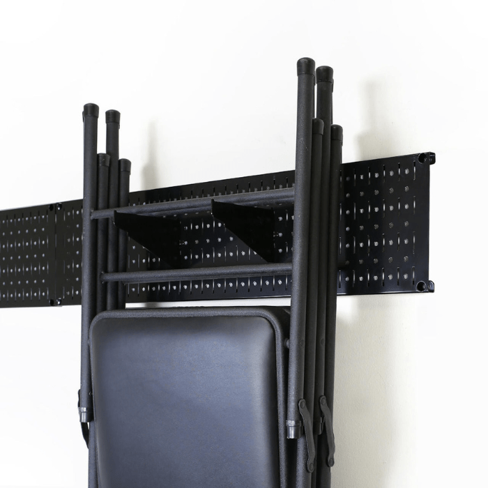 Showing the Garage Storage Lawn Garden Tool Organizer Rack by Wall Control with black accessories holding chairs