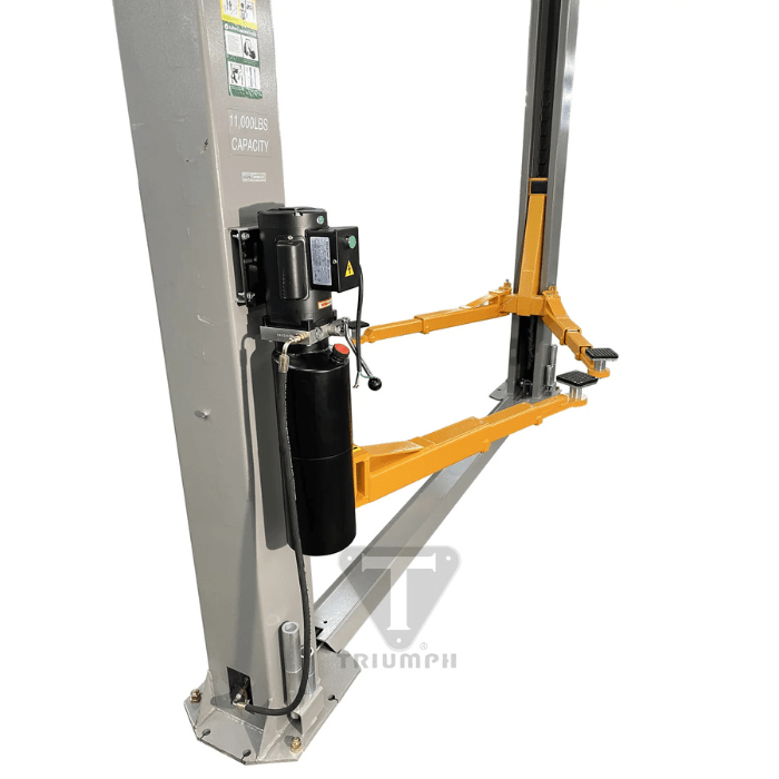 Side view of the Triumph NT-11 Two Post Car Lift highlighting the 11,000 lb capacity hydraulic power unit and dual-stage orange lift arms for heavy-duty vehicle servicing.