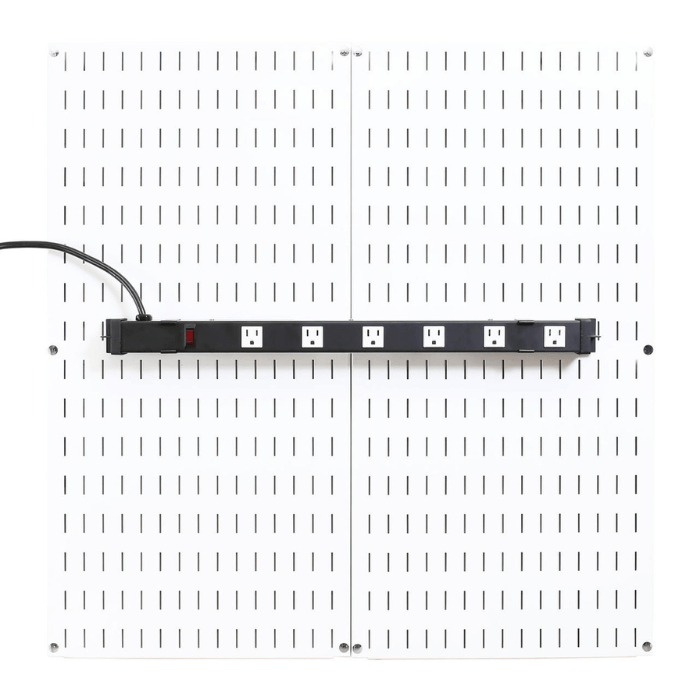 The Pegboard-Mounted Power Strip & Charging Station mounted to a white pegboard