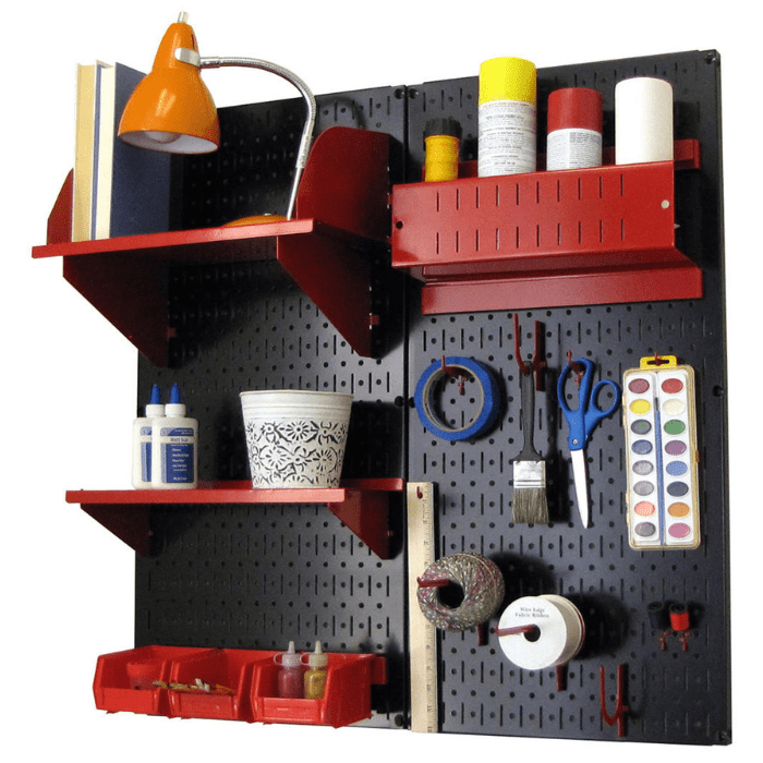 The Pegboard Organizer Kit by Wall Control with black pegboard and red accessories with craft materials