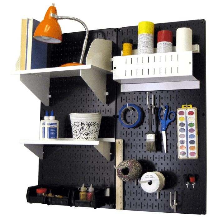 The Pegboard Organizer Kit by Wall Control with black pegboard and white accessories with materials