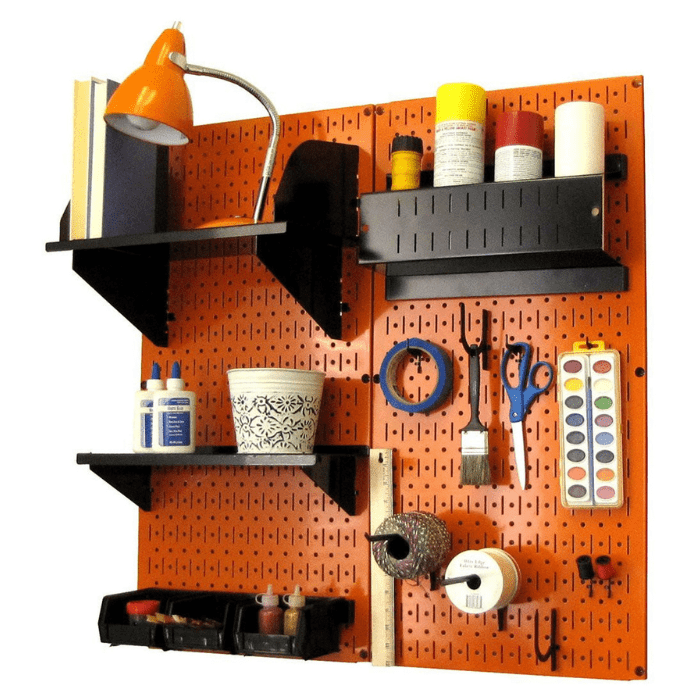 The Pegboard Organizer Kit by Wall Control with orange pegboard and black accessories with materials