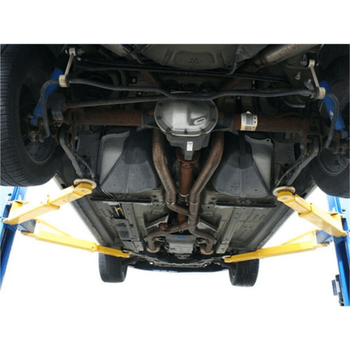 Undercarriage view of a vehicle elevated on the Atlas 9OHSC-SS 9000lb overhead lift showing lift arms securely positioned