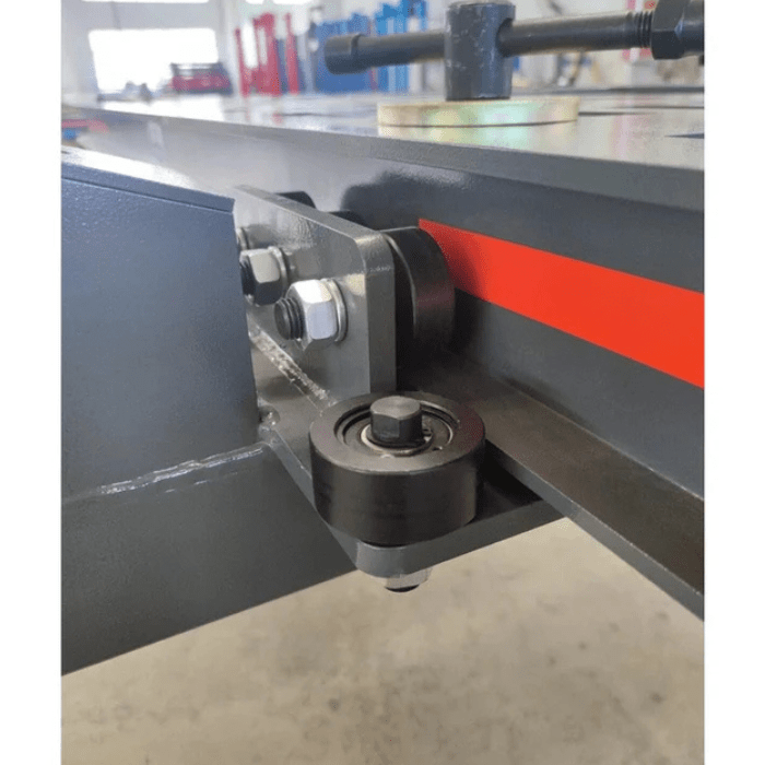 Underside view of Katool KT-299U Heavy-Duty Auto Body Frame Machine showing caster wheel and reinforced frame joint