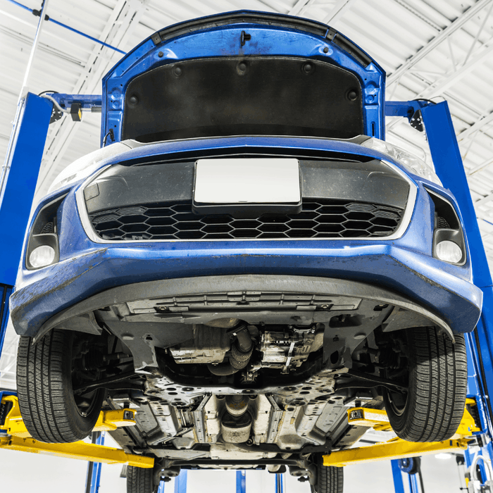 Front side upward view of a vehicle on a 2 post lift