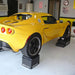 Lotus Elise raised on Race Ramps 12 inch wheel cribs in a garage
