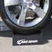 Car tire resting in the cradle of a Race Ramps 8 inch wheel crib