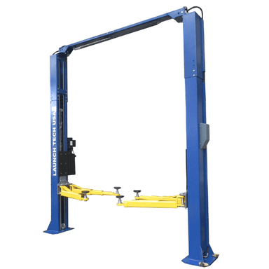 Angled front view of the Launch TLT210-XT Clear Floor Car Lift – 10,000 lb Capacity, showcasing its asymmetric arm layout, overhead bar, and reinforced blue columns.