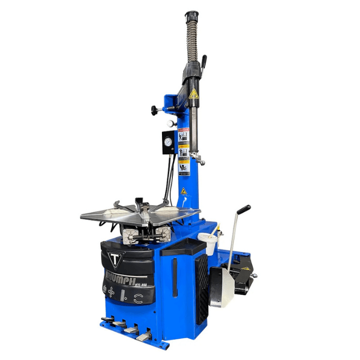 Angled side view of the Triumph NTC-950 Wheel Changer with a pneumatic assist tower, foot-operated controls, and a rotating turntable for efficient tire servicing.