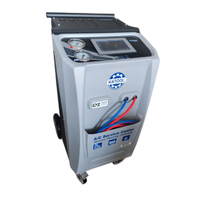 Angled top-down view of the Katool R-1234YF Dual A-C Machine – Fully Automatic Recovery, Recycle & Recharge (KT-AC2100) with gauges, touchscreen, and service hoses.