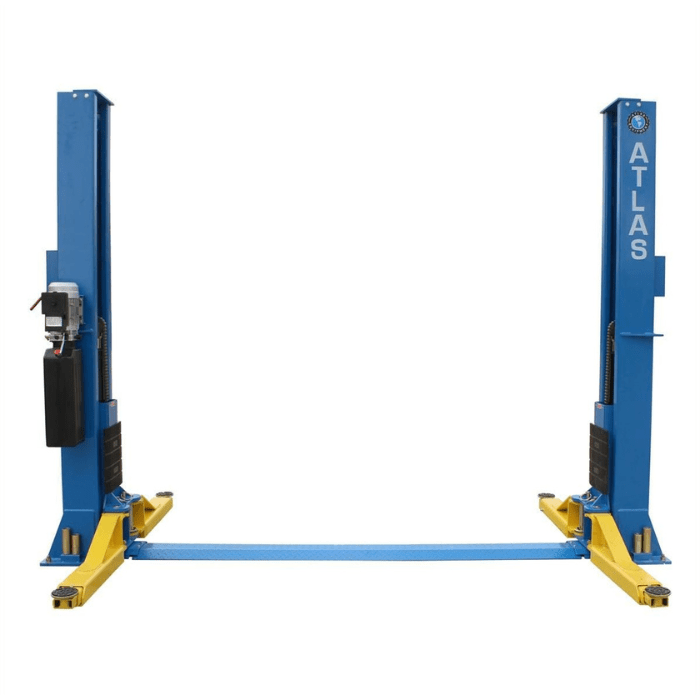 Atlas BP12000X baseplate two-post lift shown with arms lowered, emphasizing its wide stance and heavy-duty commercial frame.