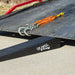 Race Ramps tow ramp positioned under the lip of a rollback bed next to the winch chain