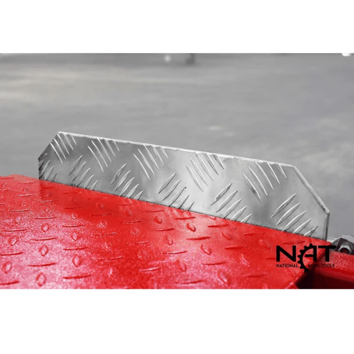 Close-up of the Triumph NOS9000XLT Four-Post Vehicle Lift’s diamond-plate wheel stop on the red runway.