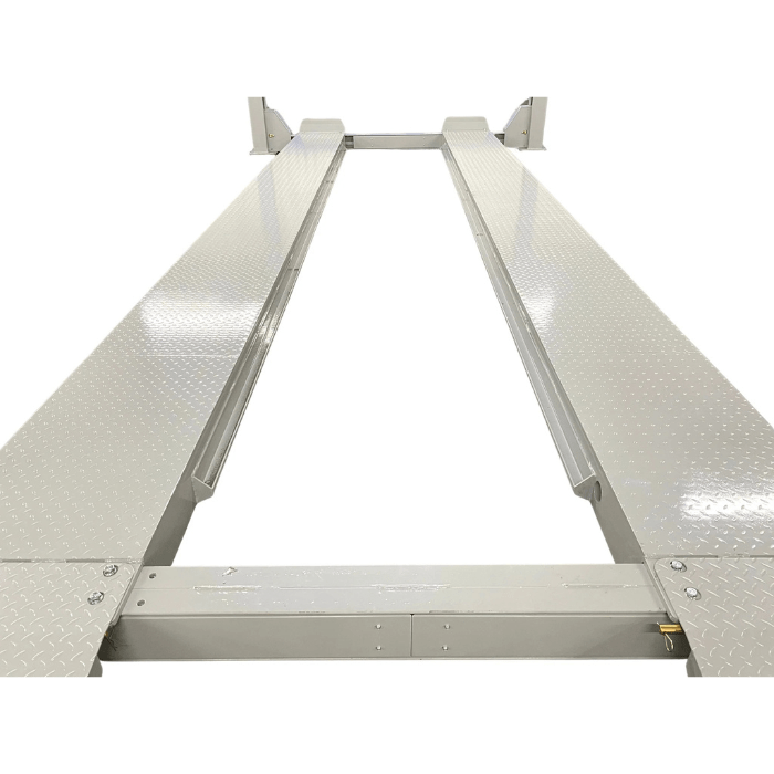Close-up of the Triumph NTR-32 Commercial Four-Post Vehicle Lift’s long diamond-plate runways, designed for heavy-duty vehicle support.