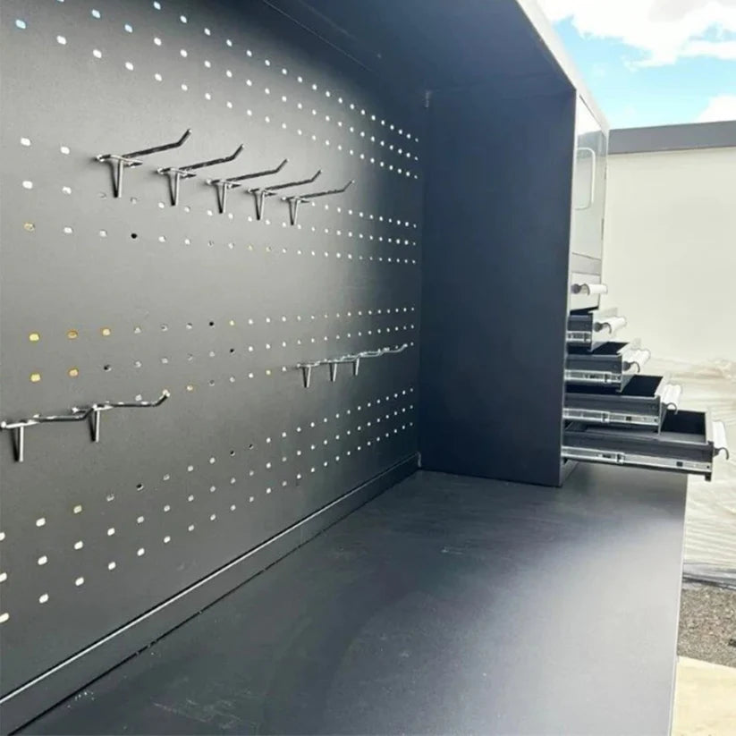 Close up of Chery Industrial 10 foot workbench cabinet pegboard panel showing accessory hooks and workspace backsplash