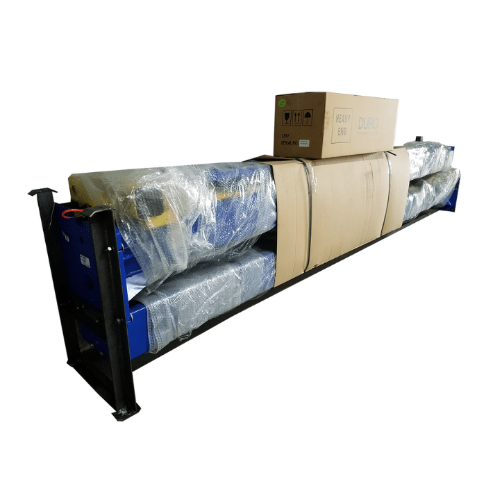 Factory-wrapped TP9KACX two-post lift packaged on a steel skid with protective cardboard and stretch film, ready for freight delivery.