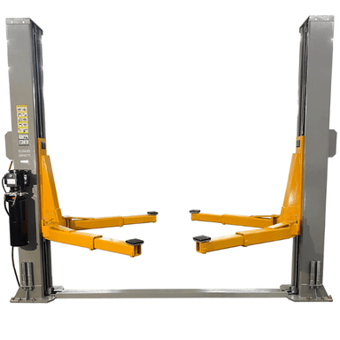 Front view of the Triumph NT-15 15,000 lb Two-Post Auto Lift with dual grey columns, heavy-duty orange arms, and a mounted hydraulic power unit for high-capacity vehicle lifting.