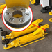 Katool KT-PMRL200 8000lb Two-Post Lift – close-up of arm gear locking mechanism and adjustable lift pads.