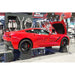 Corvette displayed on Race Ramps show cribs at an indoor show