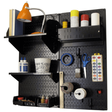 The Pegboard Organizer Kit by Wall Control with black pegboard and black accessories with materials
