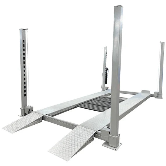Triumph NOS10000 10,000 lb 4 post car lift studio view with runways and lowered approach ramps
