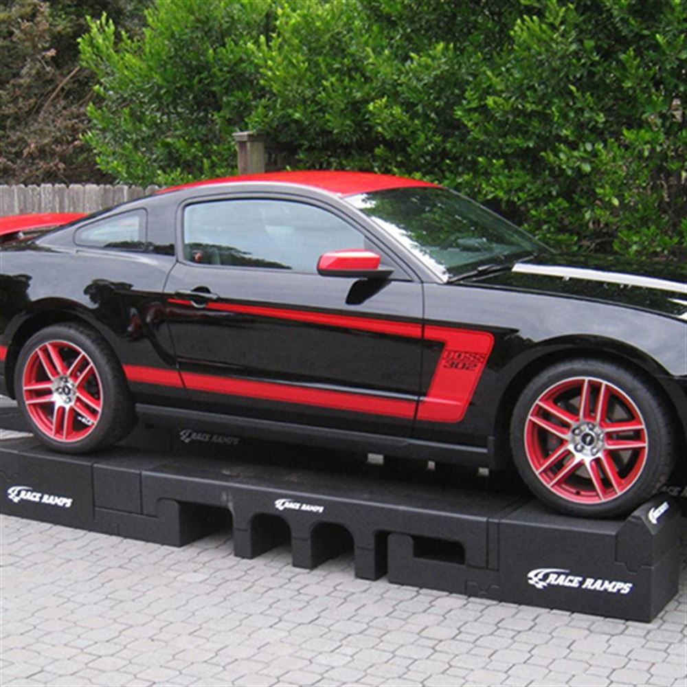 Mustang elevated on Portable Pit Stop Ramps for underbody access