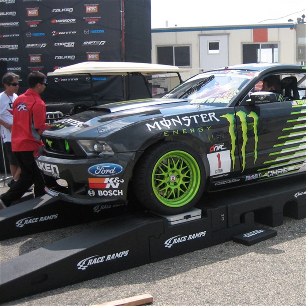 Race car displayed on Portable Pit Stop Ramps at a trade show