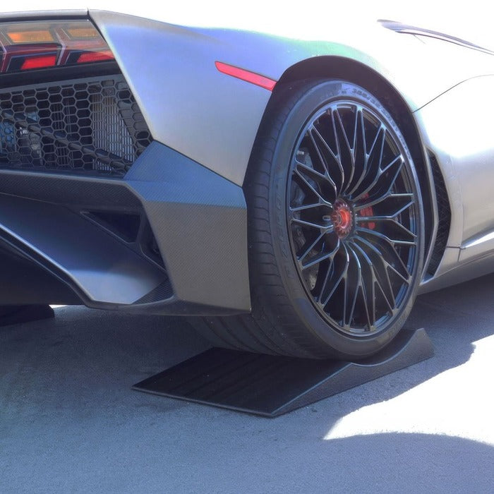 Sports car tire parked on a Race Ramps FlatStopper