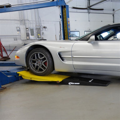 Corvette driven onto Race Ramps shop ramps to reach a two post lift