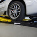 Race Ramps shop ramp positioned alongside a two post lift arm