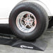 Wide drag tire resting on a Race Ramps Show Ramp