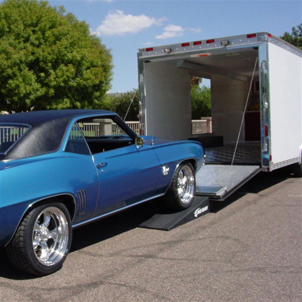 Blue muscle car driving up Race Ramps RR-TR-4 trailer ramps into an enclosed trailer